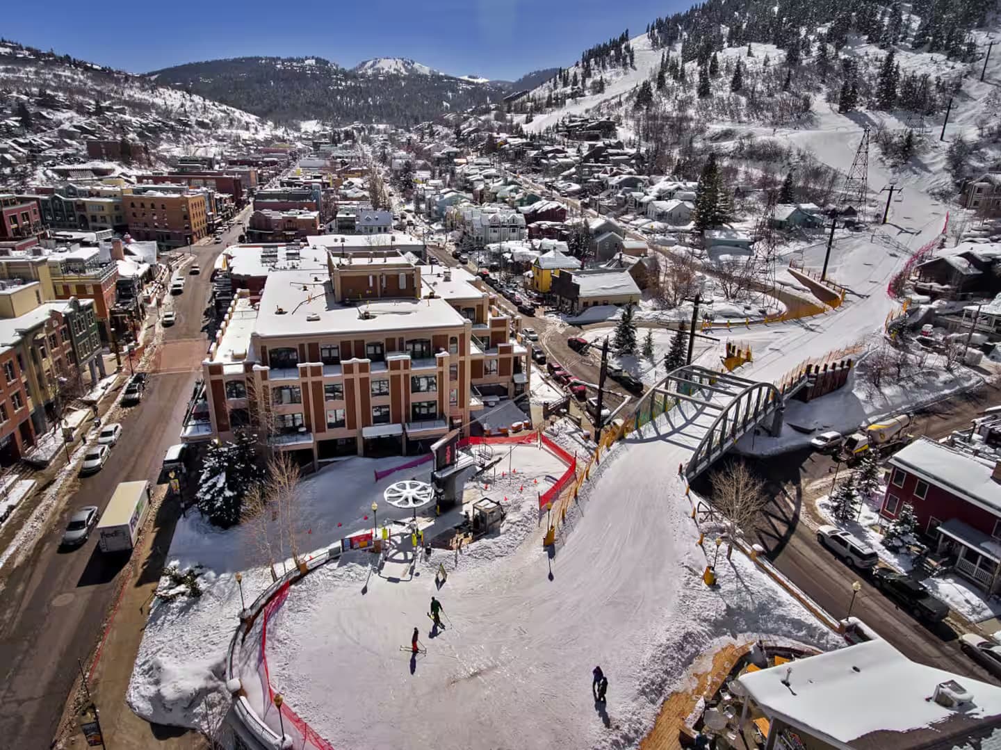 Aerial view of snow-covered Park City Old Town with ski runs descending into Main Street