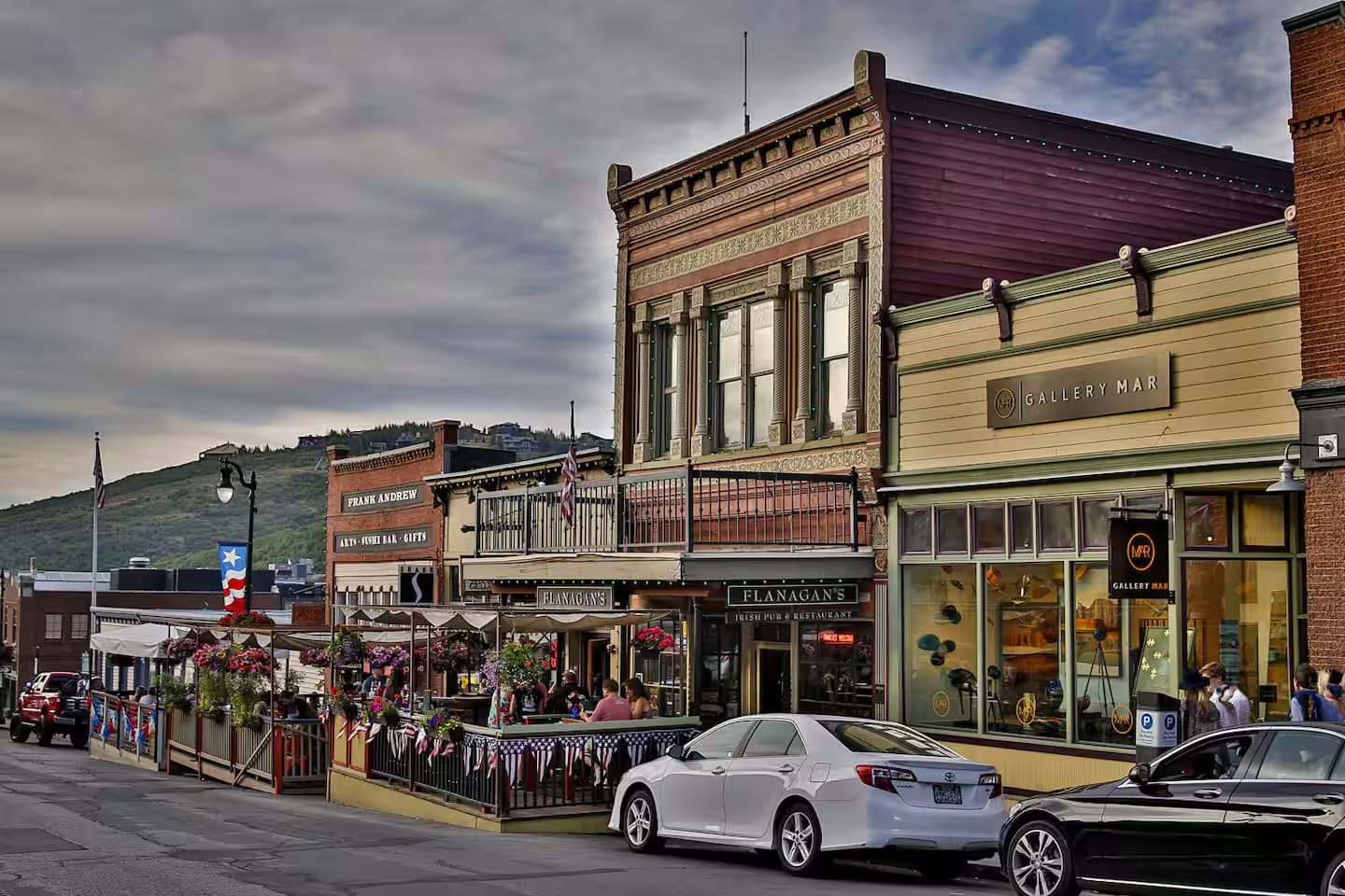 Cars along Park City's historic Main Street with the Wasatch foothills beyond