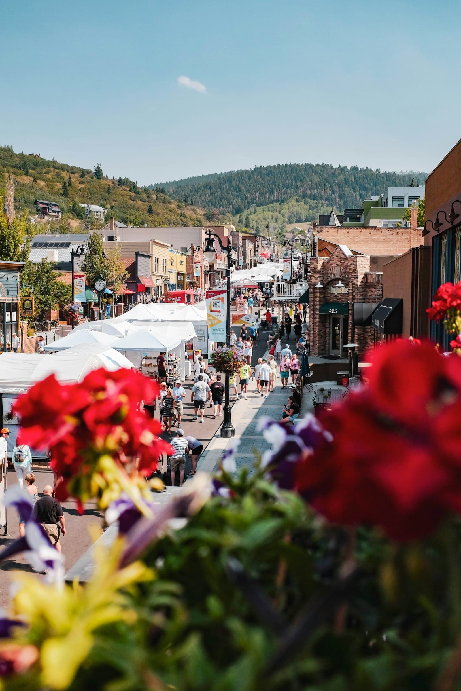 Festival crowd and white tents lining Park City's Historic Main Street