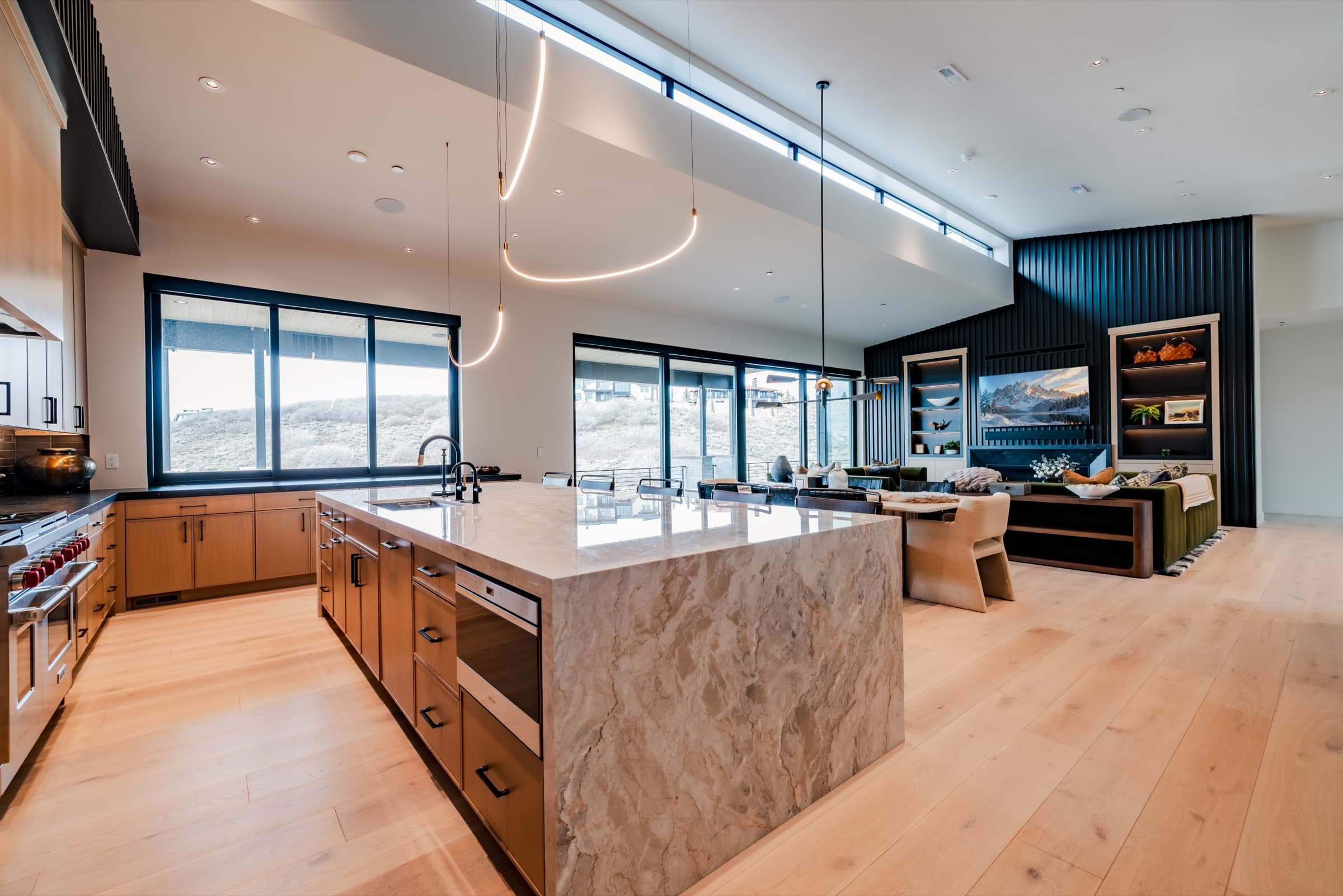 Open kitchen with a stone waterfall island in a luxury Park City home