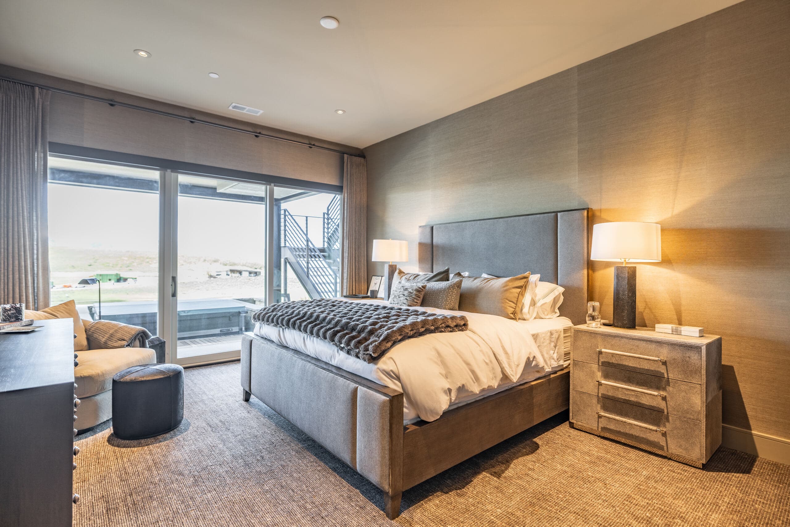 Primary bedroom of a luxury Park City home with mountain views through floor-to-ceiling windows