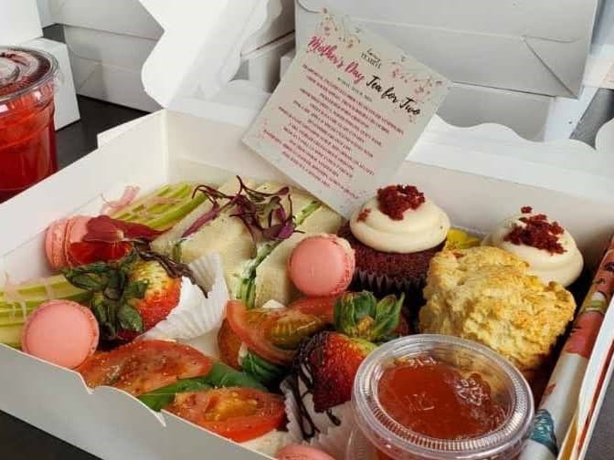 Curated afternoon tea box with pastries and finger sandwiches