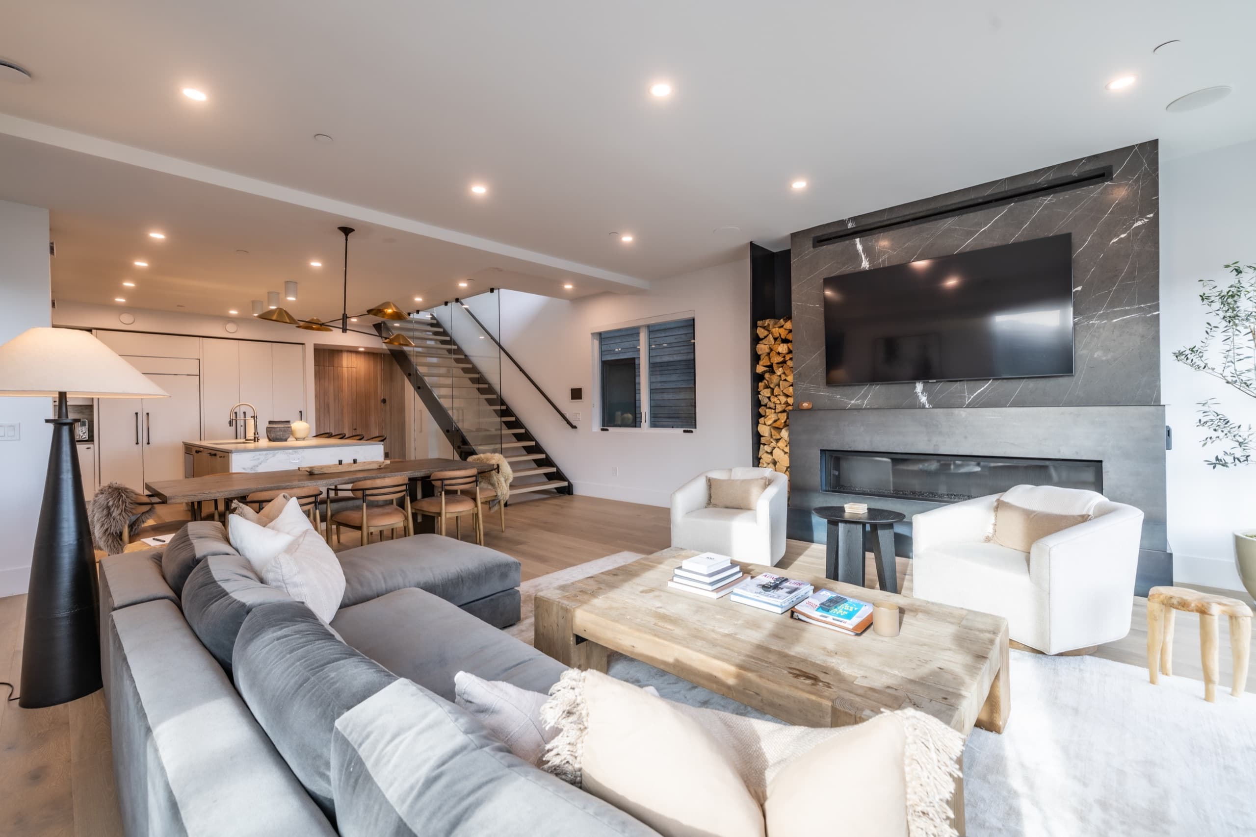 Warmly lit luxury Park City home at twilight with mountain views