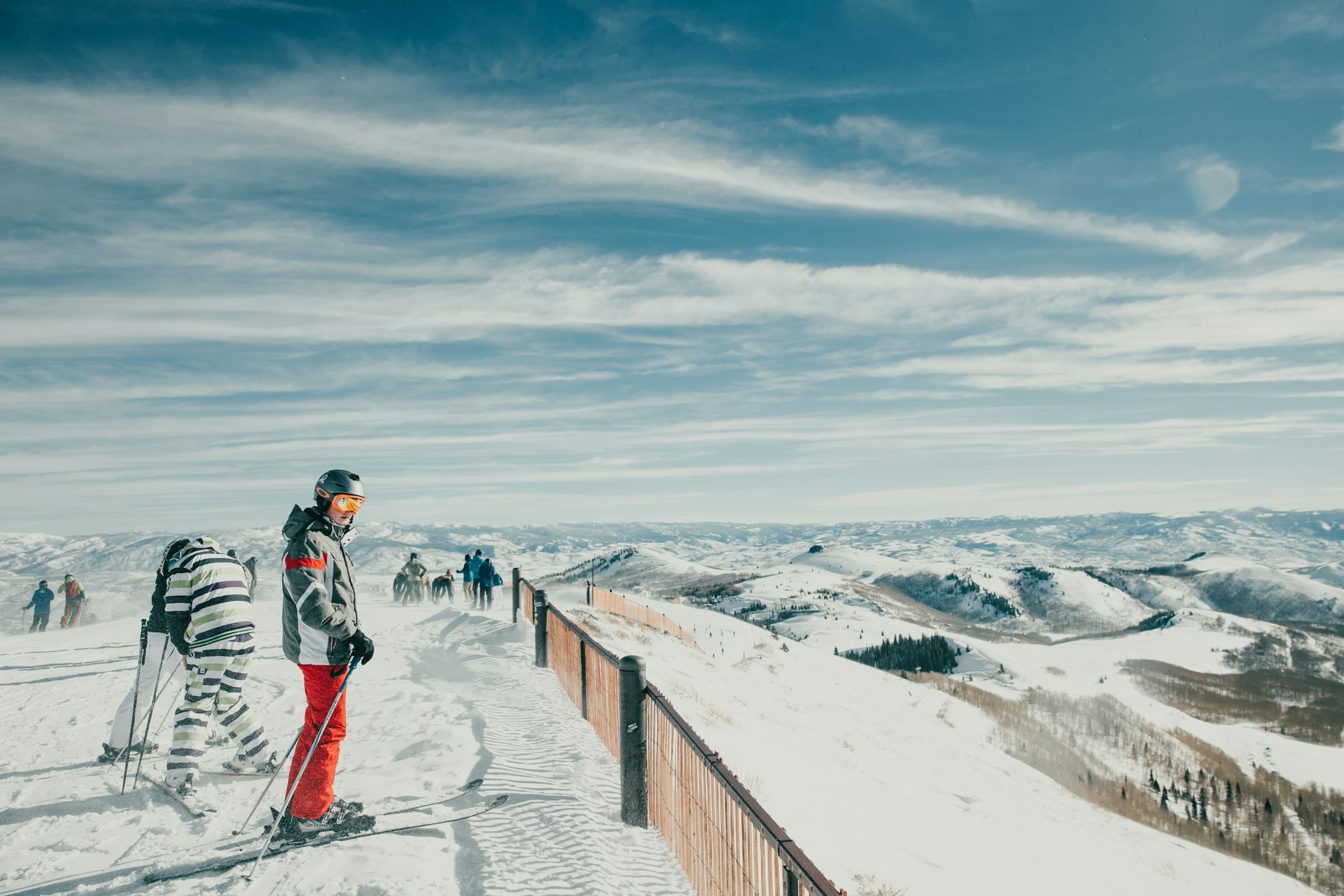 Skier standing atop a snow-covered slope in Park City